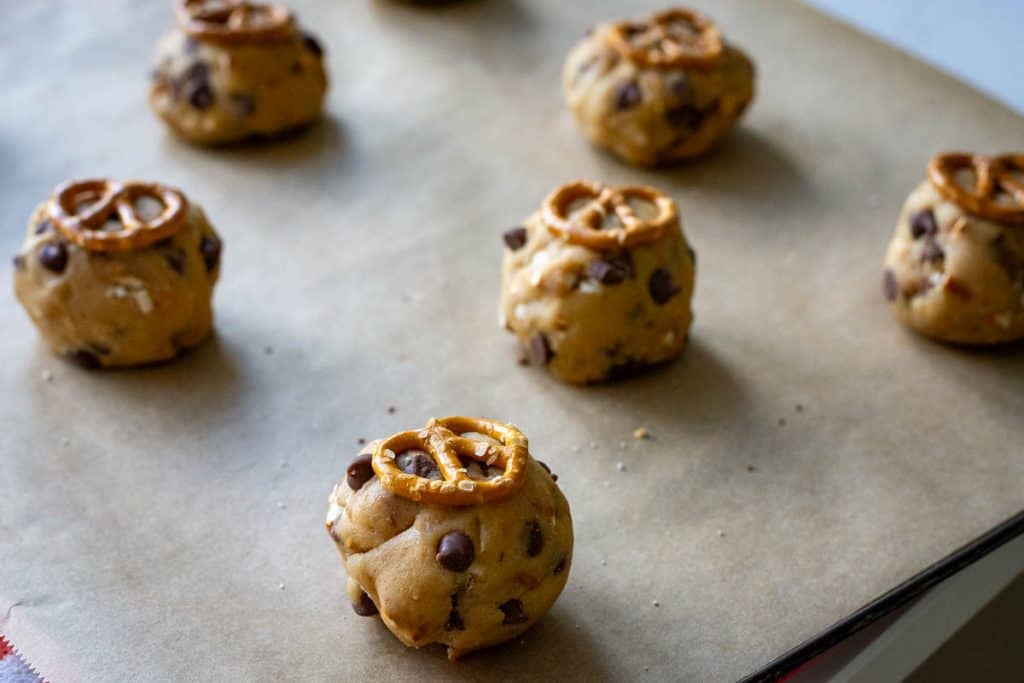 Whole salted pretzel pressed on top of each sourodugh cookie dough ball.