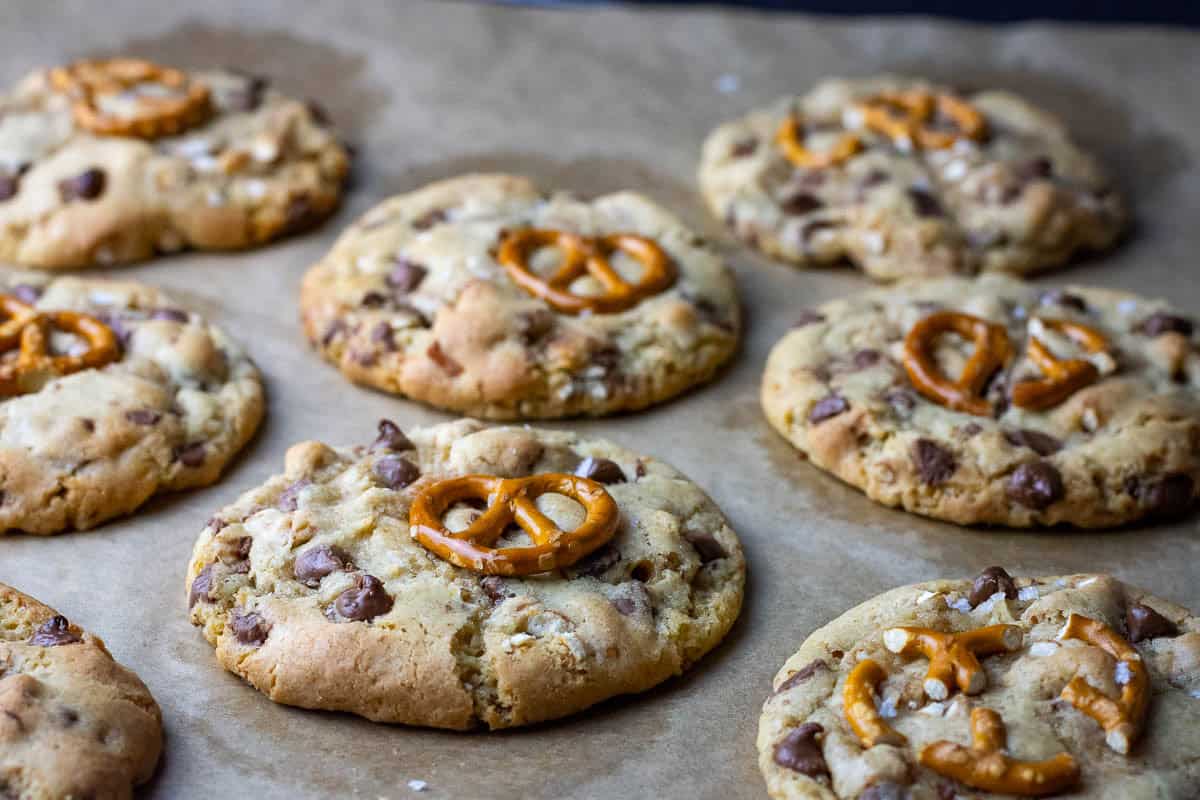 Baked sourdough chocolate chip pretzel cookies on a baking sheet.