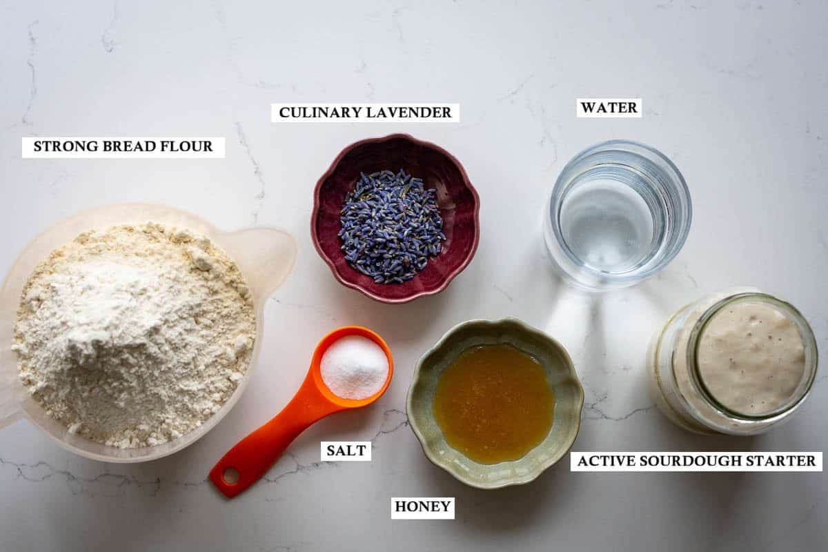 Labelled ingredients for Lavender sourdough bread on a light worktop.