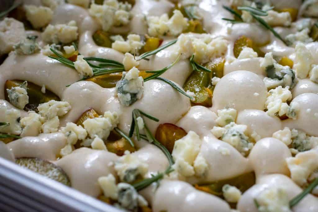 Sourdough focaccia dough topped with plums, gorgonzola and rosemary.
