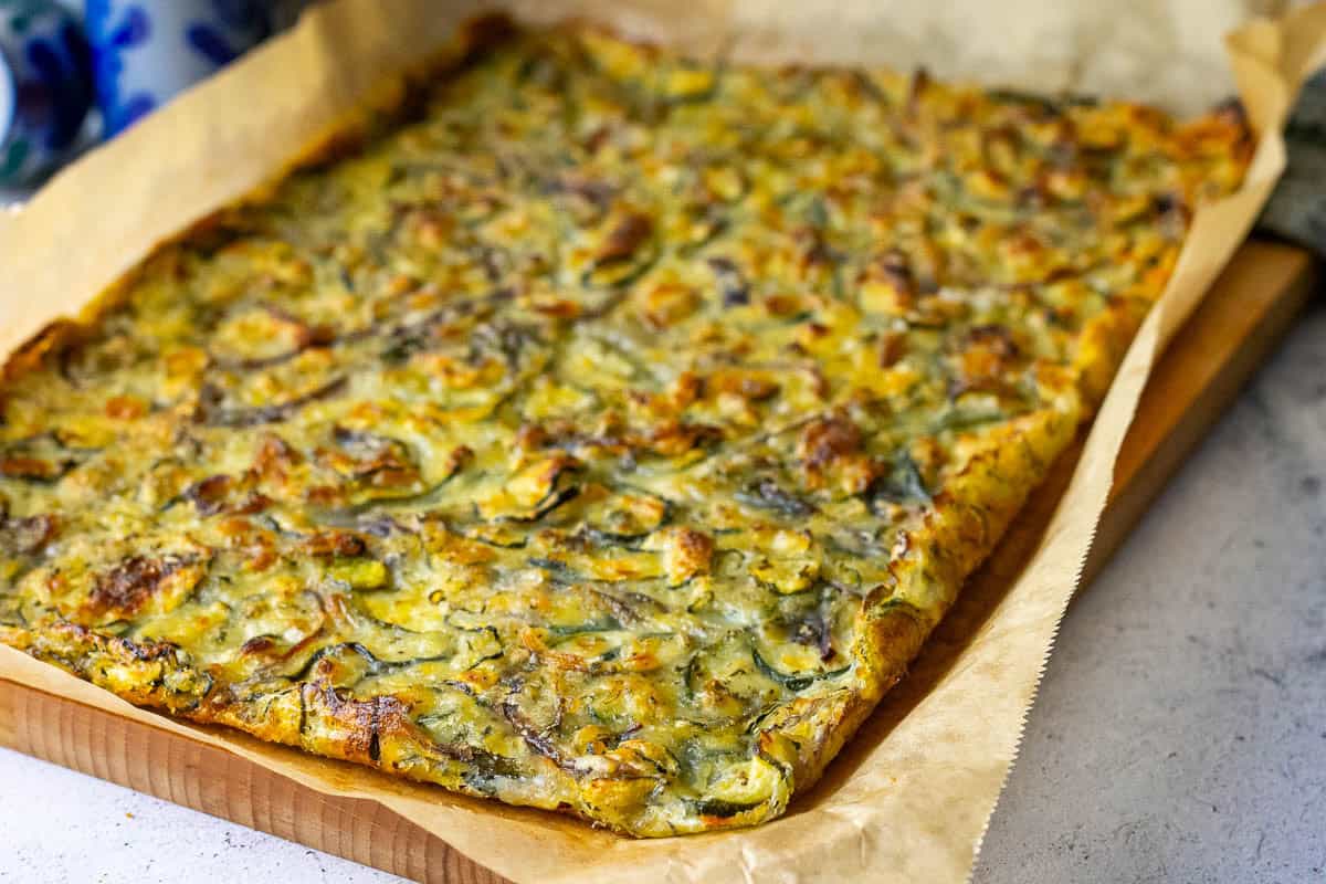 Sourdough discard zucchini scarpaccia with golden brown crispy egdes.