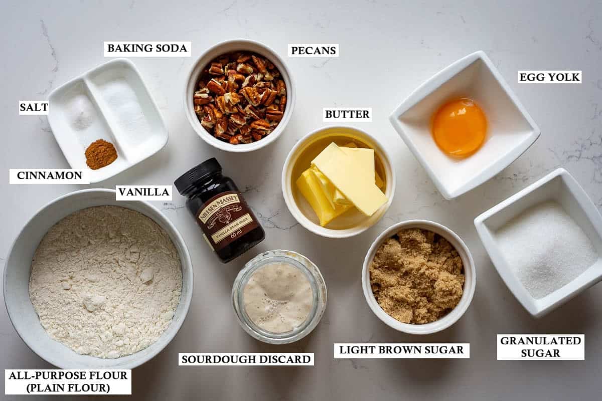 Labelled ingredients for sourdough butter pecan cookies on a light kitchen worktop.