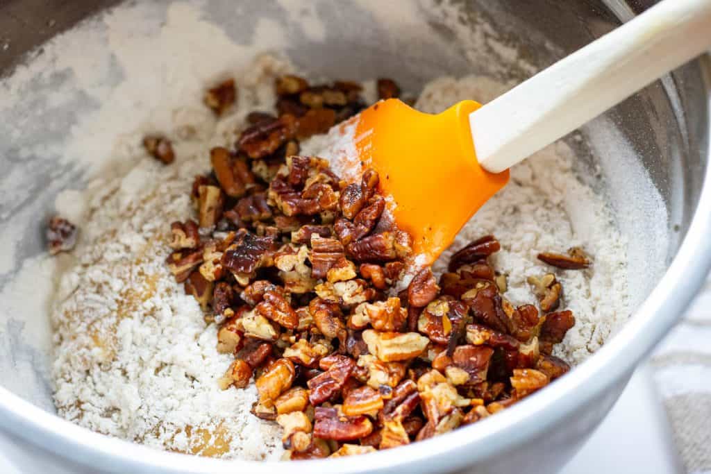Mixing in the butter pecans into sourdough cookie dough.