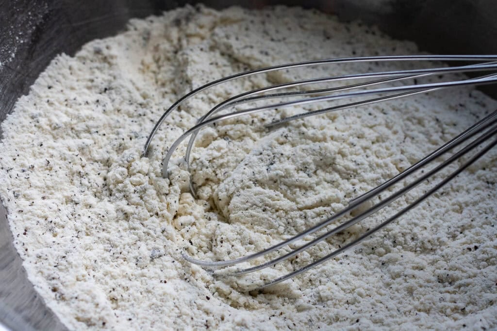 Mixing the flour mixture with a balloon whisk.