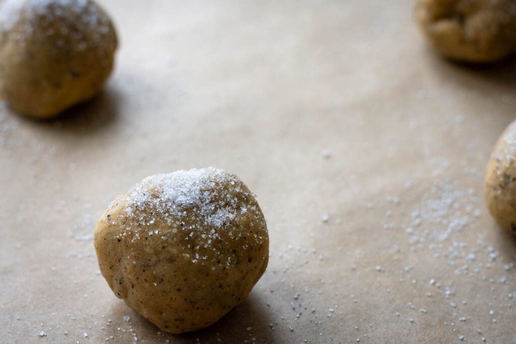 Earl grey sourdough cookie dough balls sprinkled with sugar.