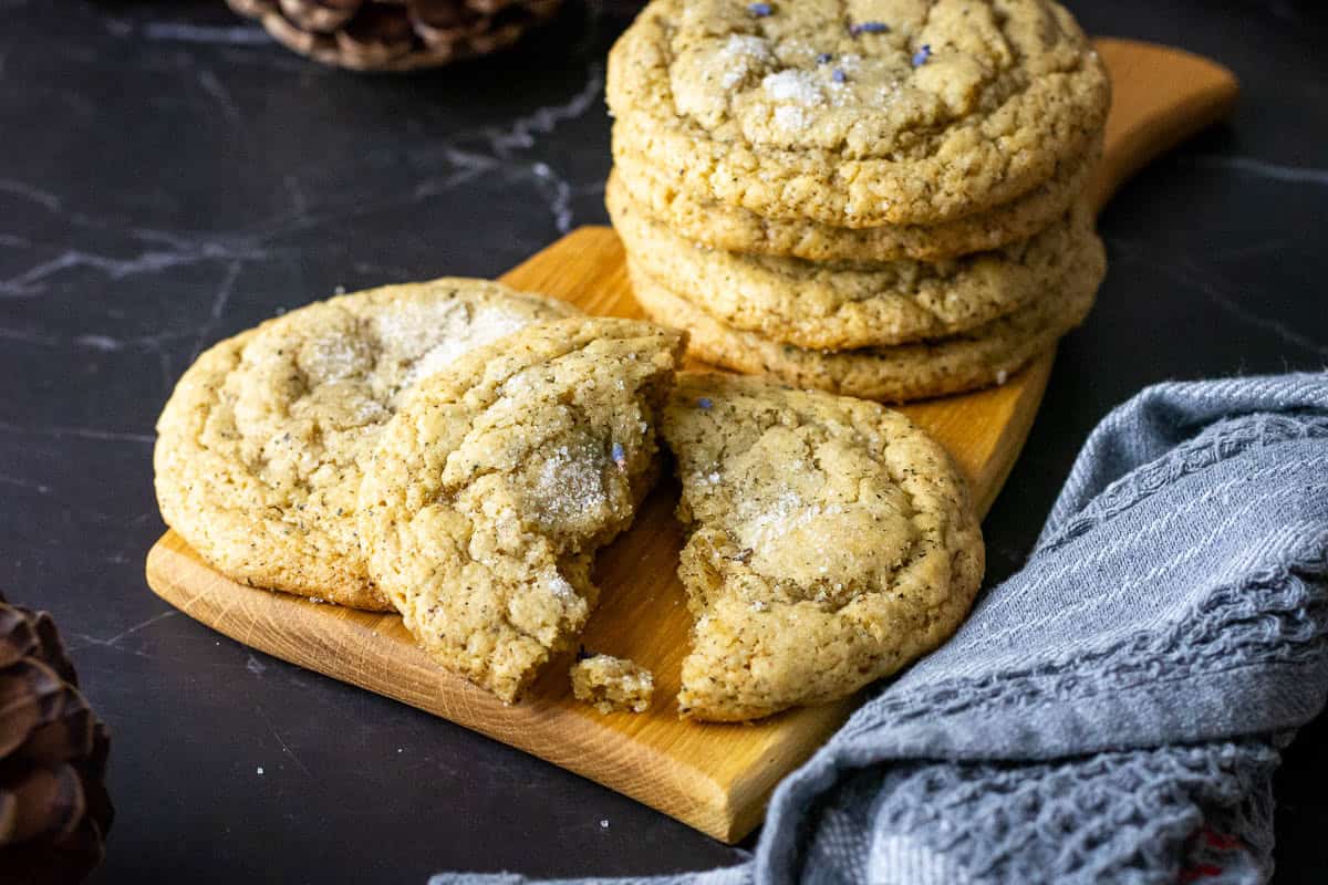 Stacks of London Fog Sourdough Cookies With Earl Grey on a wooden board.