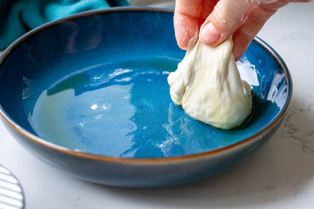 Dipping the sourdough focaccia muffin dough in oil.