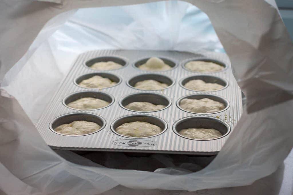 Sourdough focaccia muffin placed in a plastic bag for second rise.