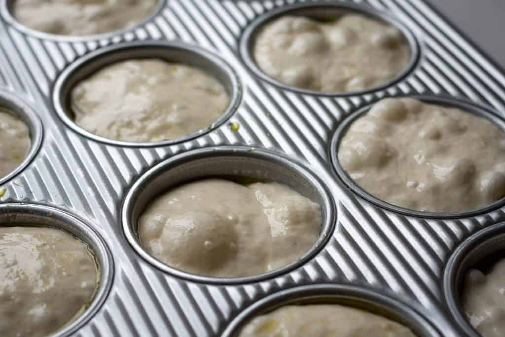 Bubbly and blistered sourdough focaccia muffins after the second rise.