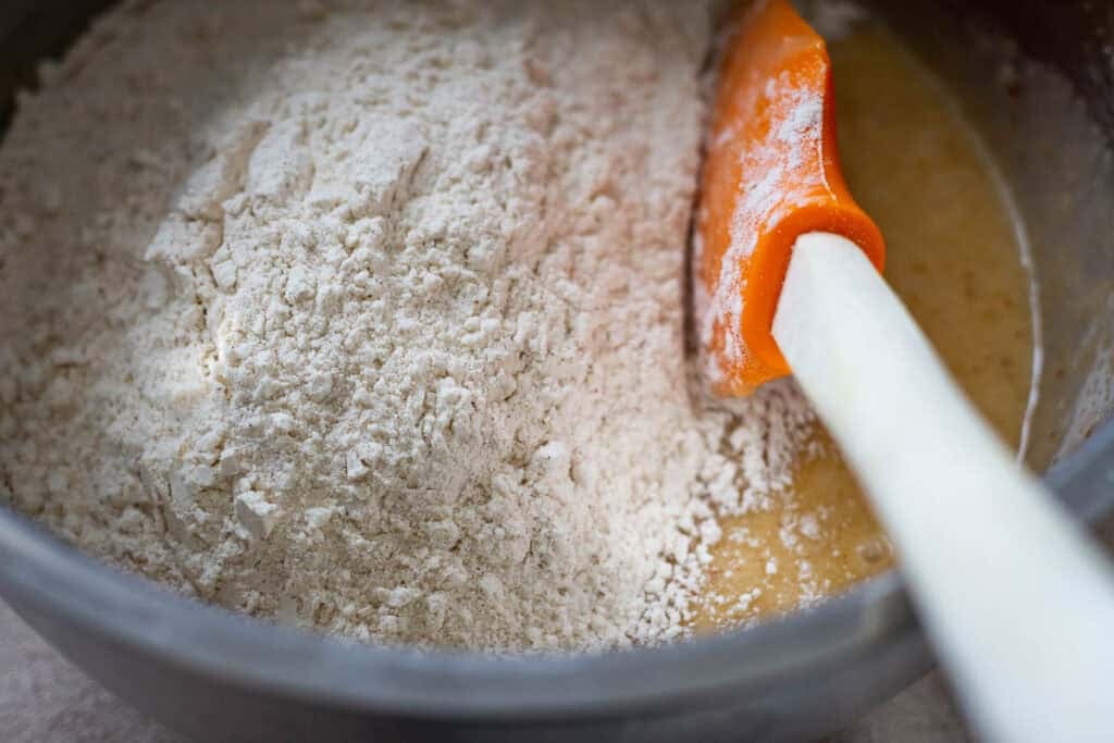 Flour mixture being stirred into the wet ingredients.