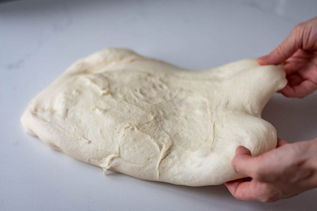 Shaping sourdough pullman loaf.