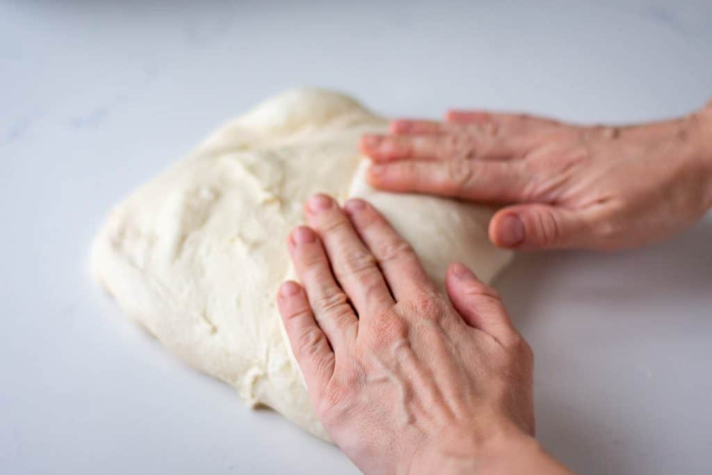 Shaping sourdough pullman loaf.
