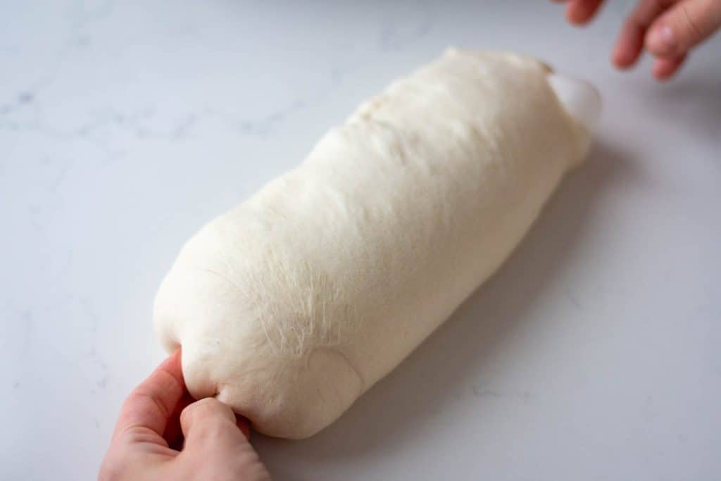 Shaping sourdough pullman loaf.