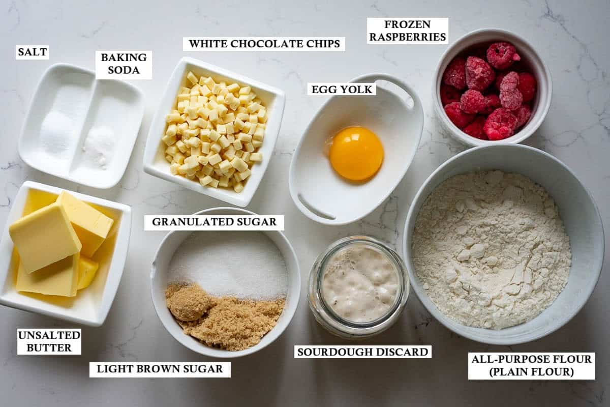 Labelled ingredients for sourdough discard cookies with raspberries and white chocolate chips.