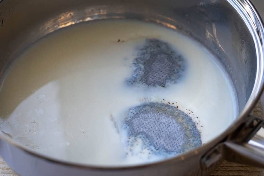 Earl Grey tea bags in steeping in milk.