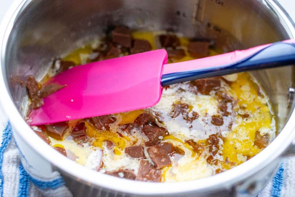 Melting chocolate in butter and cream.