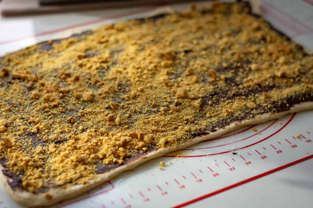Crushed Graham crackers spread across the chocolate filling.