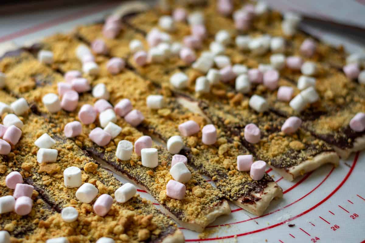Rolled-oout sourdough topped with s'mores filling cut into strips.