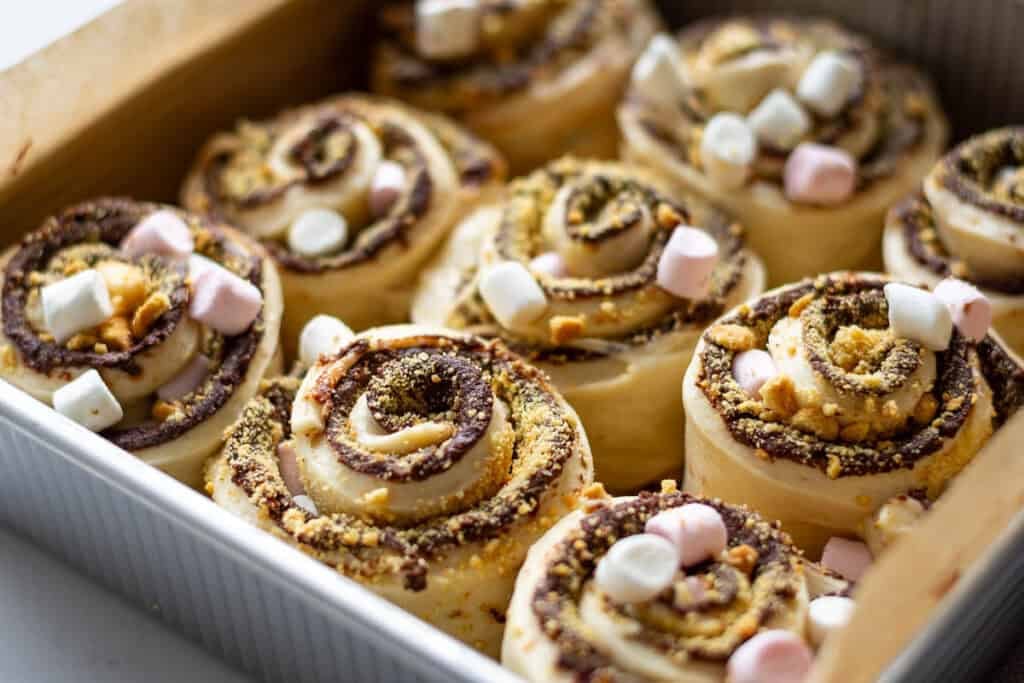 Sourdough s'mores rolls arranged in a square baking pan.