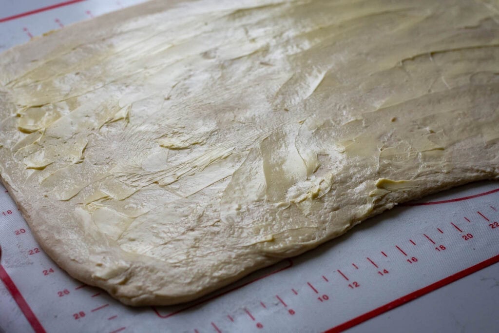Rolled out sourdough with butter spread on top.