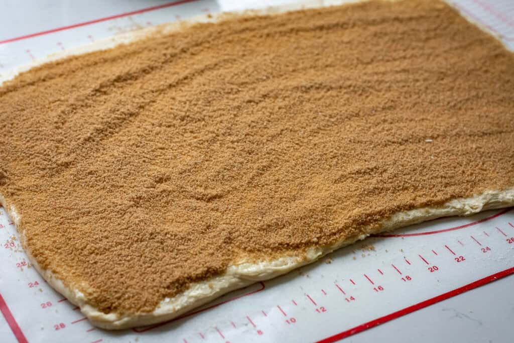 Cinnamon sugar spread across the buttered rolled out sourdough.