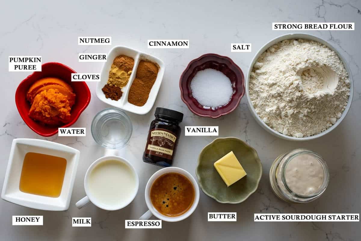 Labelled ingredients for Pumpkin Spice Latte Sourdough Bread on a light kitchen worktop.