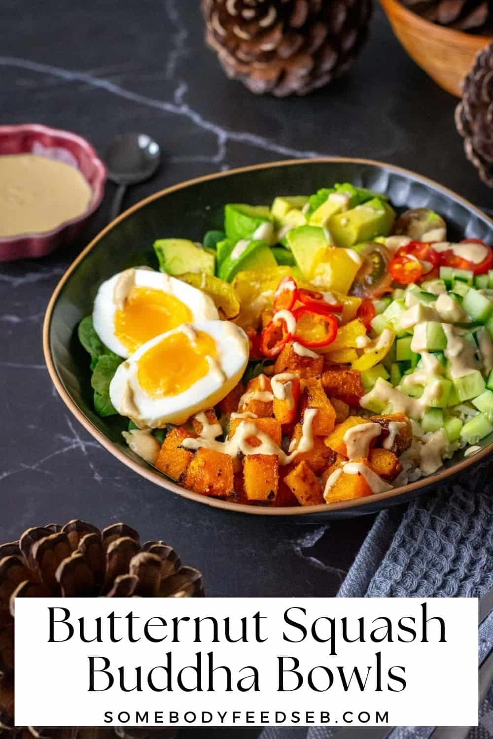 Roasted Butternut Squash Buddha Bowls With Soft Boiled egg and tahini drizzle in a black bowl. Pin for Pinterest.