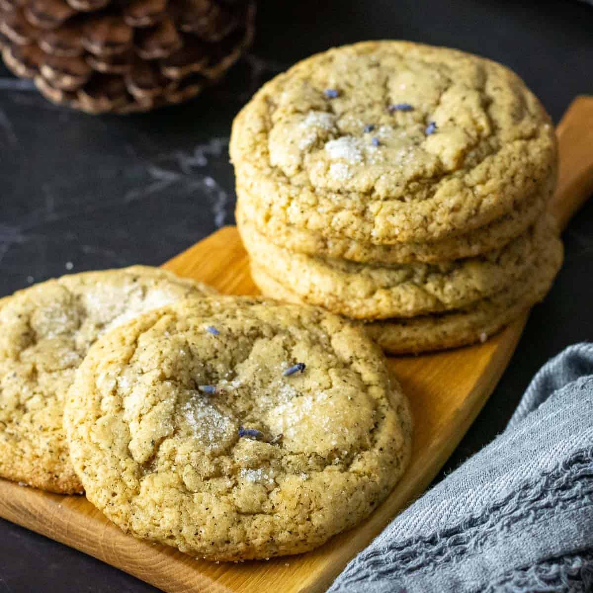 Stacks of London Fog Sourdough Cookies With Earl Grey on a wooden board.