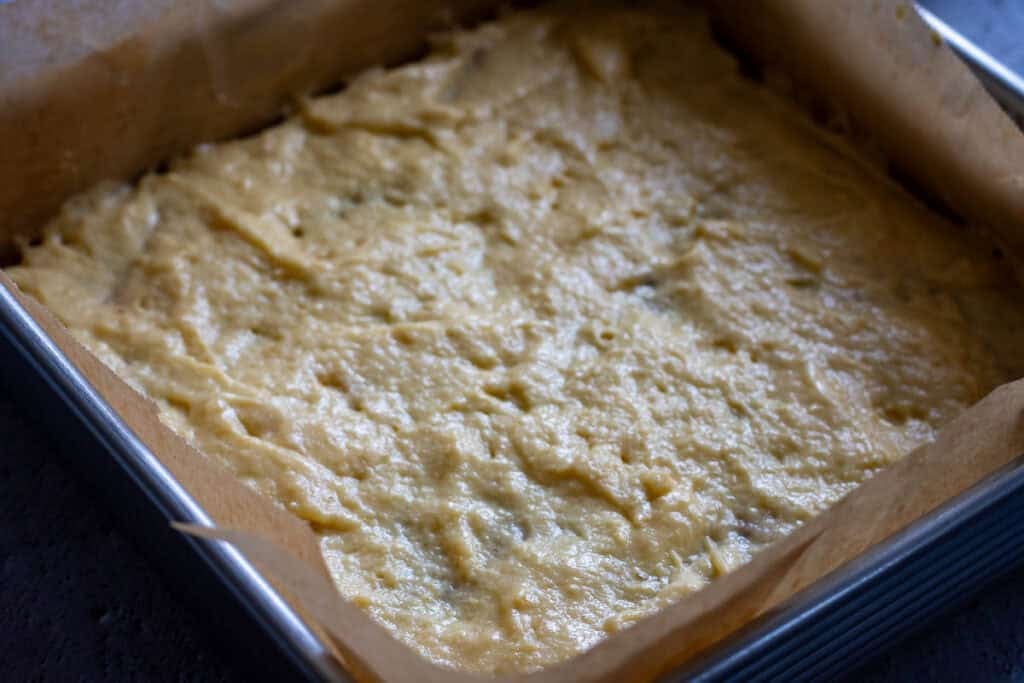 The remining sourdough cake batter spread across the cinnamon sugar layer.