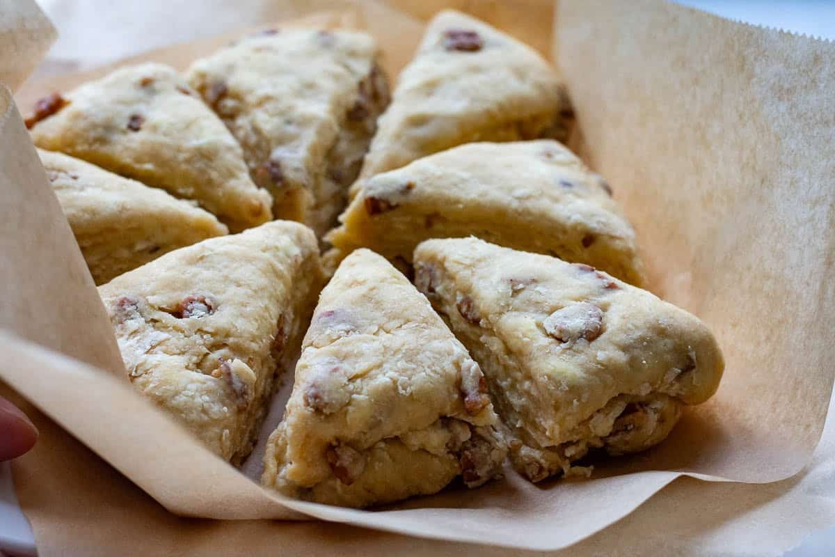Quick frozen sourdough discard scones on a piece of parchment paper.