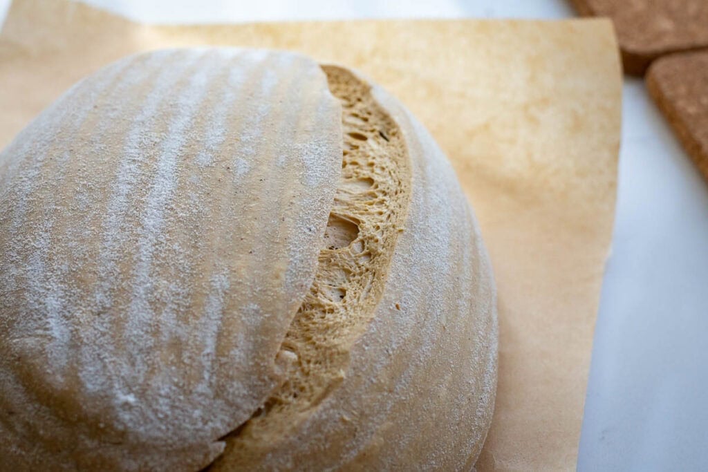 One slash across the side of sourdough showing airy exterior in the well fermented dough.