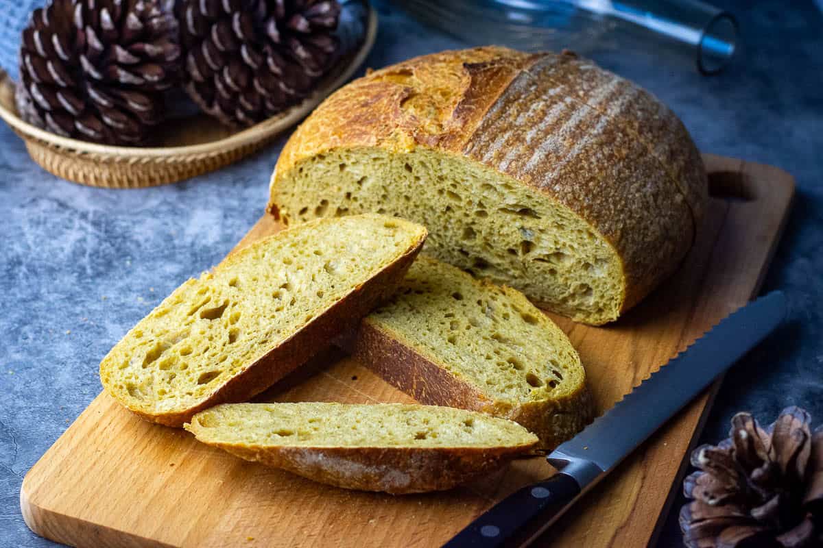 Sliced pumpkin spice latte sourdough bread on a wooden board.