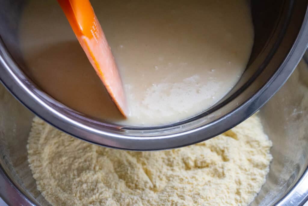 Pouring wet ingreeints into the dry ingredients.