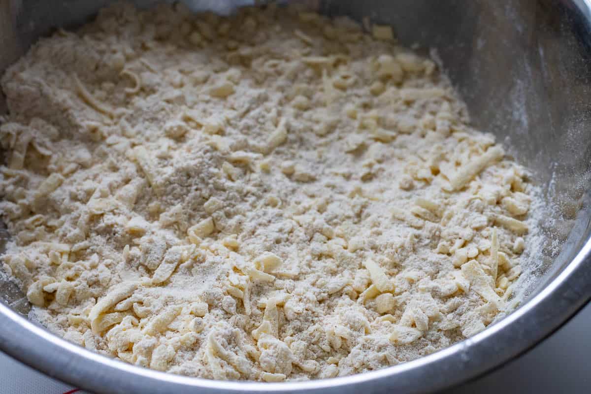 Flour and frozen butter mixture in a large mixing bowl.