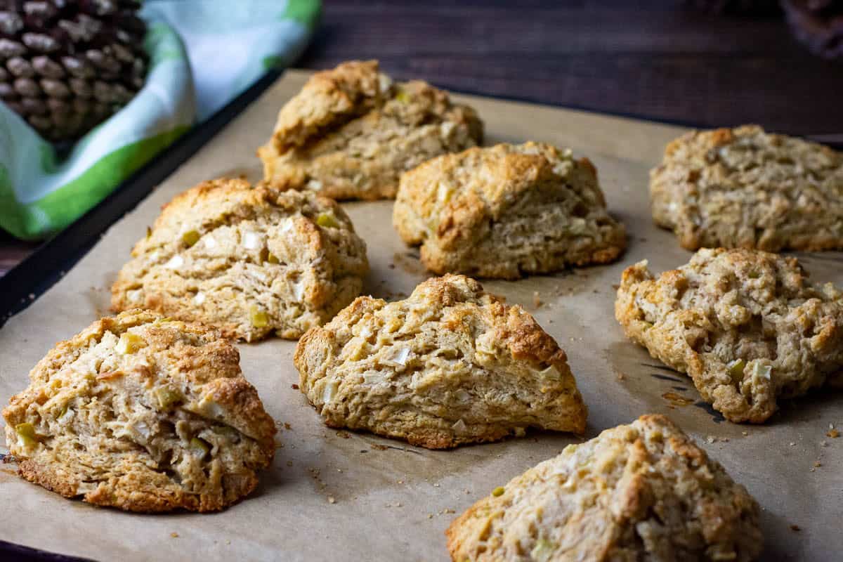 Baked sourdough apple scones on a baking sheet lined with parchment paper.