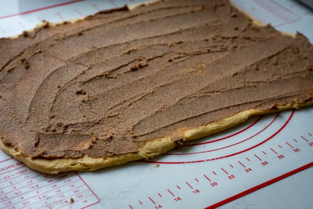 Spiced sugar butter mixture spread on the rolled out dough.