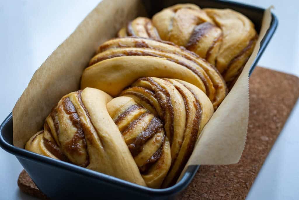 Sourdough pumpkin babka placed into a loaf pan.