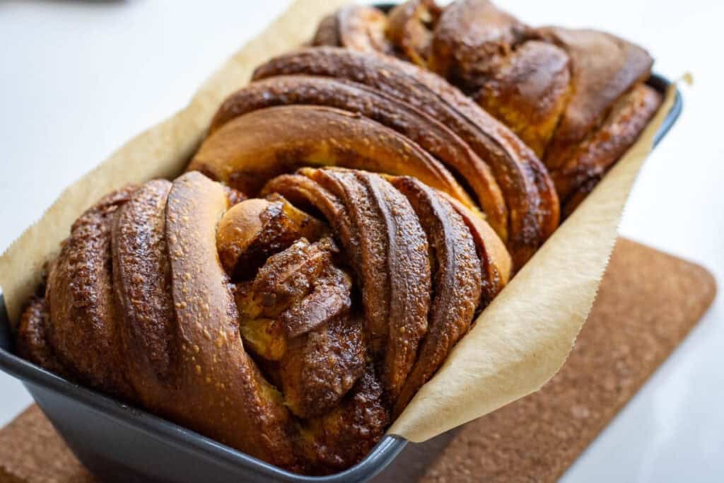 Baked sourdough pumpkin babka still in a loaf pan.