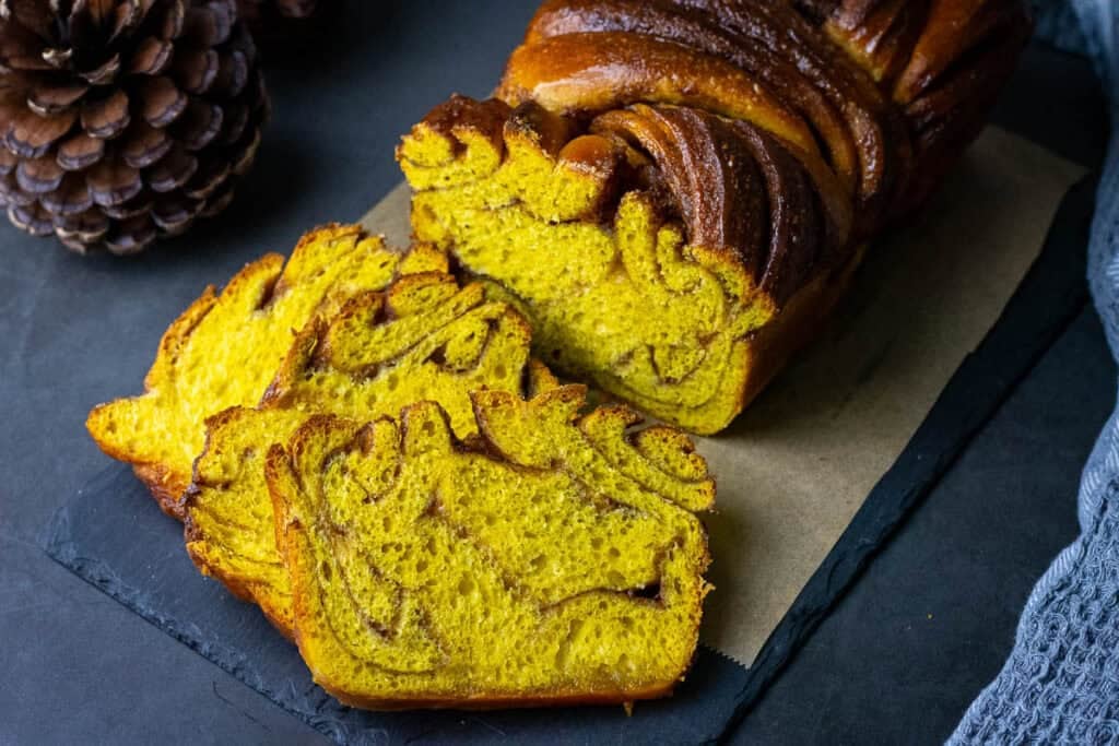 Sliced sourdough pumpkin babka on a serving board.