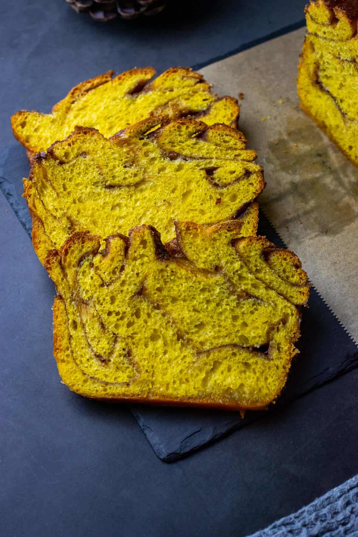 Three slices of sourdough pumpkin babka with cinnamon sugar swirl.