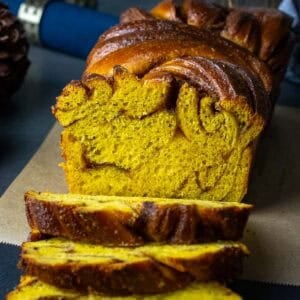 Sourdough Pumpkin Babka swirled with cinnamon sugar with three slices already cut.